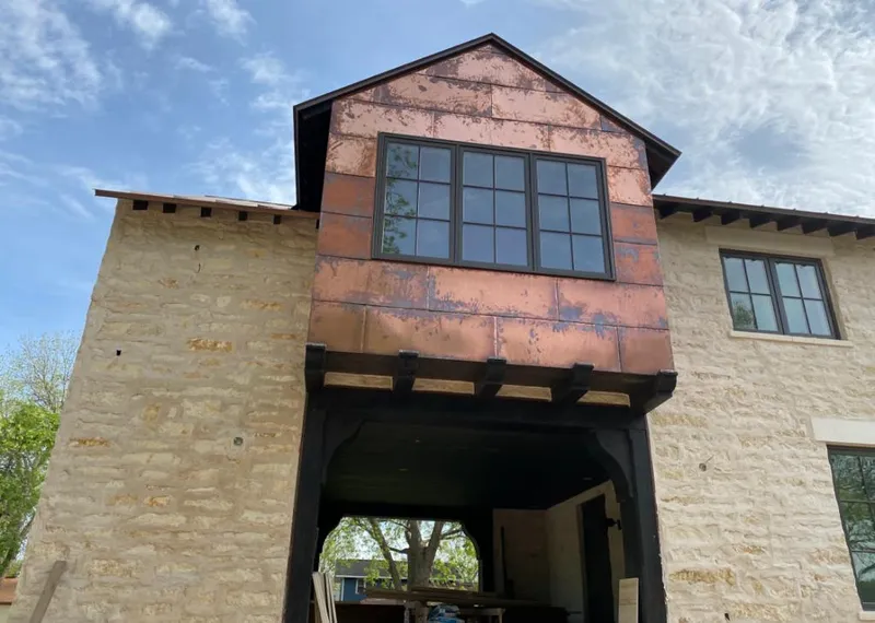 Copper metal panel facade on a stone building for Metal Roof Coating in Holladay
