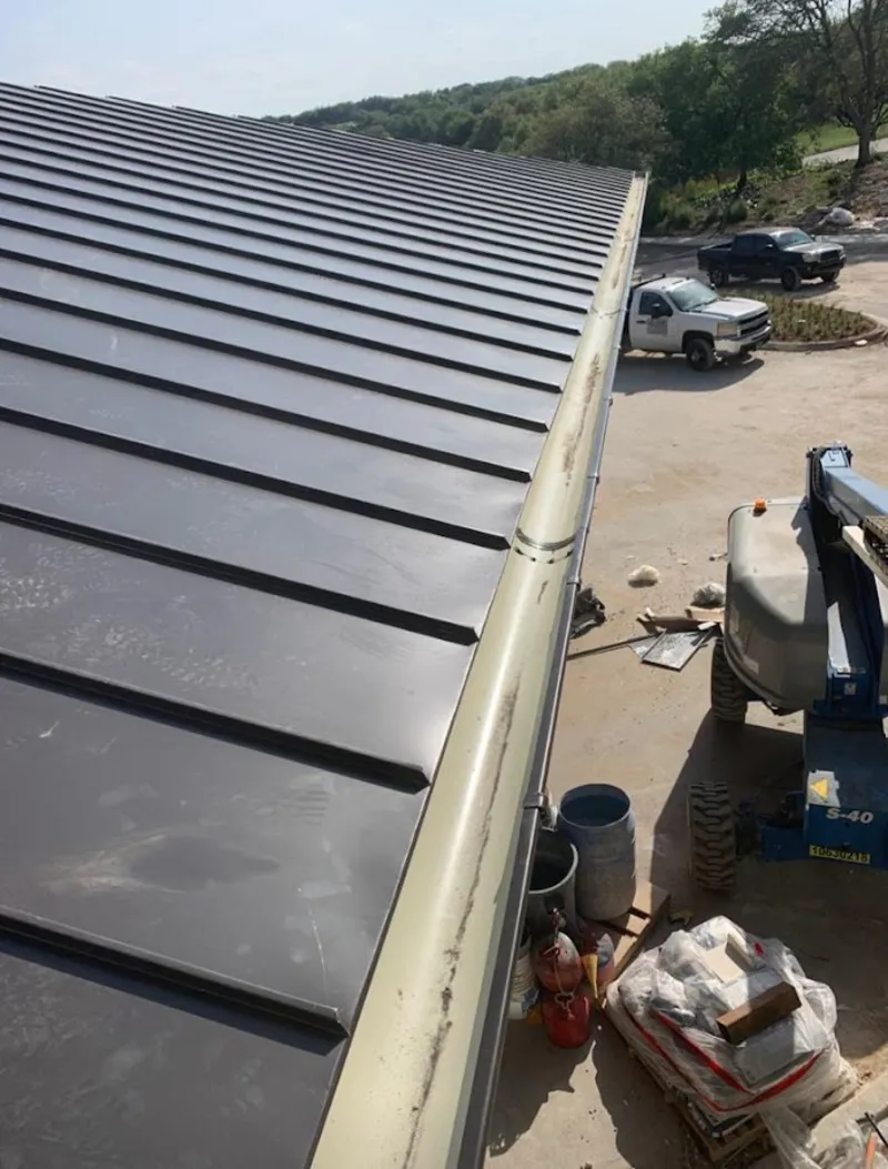 Standing seam panel and gutter detail on a metal roofing jobsite in Holladay